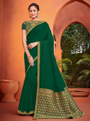 The fabulous pattern makes this Dark green color silk fabrics saree. Ideal for party, festive & social gatherings. this gorgeous saree featuring a beautiful mix of designs. Its attractive color and designer heavy embroidered silk design, stone design, beautiful floral design work over the attire & contrast hemline adds to the look. Comes along with a contrast unstitched blouse.