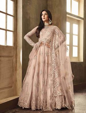 Look Amazing Charming In This Very Pretty Dusty Pink Colored Heavy Designer Floor Length Suit. Its Heavy Embroidered Top And Dupatta Are Fabricated On Net Paired With Santoon Bottom. It Has Beautiful Tone to Tone Embroidery Which Is Giving It A Subtle And Heavy Look, Both At The Same Time. 