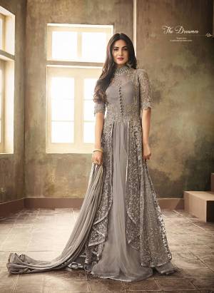 Flaunt Your Rich And Elegant Taste Wearing This Heavy Designer Suit In Rich Grey Color. Its Heavy Embroidery Top Is Fabricated On Net Paired With Santoon Bottom And Chiffon Fabricated Dupatta. Its Rich Color, Heavy Work, Unique Pattern Will Definitely Earn You Lots Of Compliments From Onlookers. 