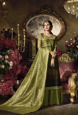 Grab This Designer Semi-Stitched Suit In Shaded Green And Black Colored Top Paired With Green Colored Bottom And dupatta. Its Top Is Fabricated On Satin Georgette Paired With Santoon Bottom And Banarasi Art Silk Dupatta. Get Lovely Plazzo Styled Suit Now.
