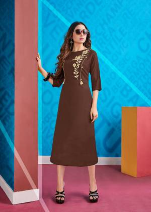 Here Is A Designer Readymade Kurti In Brown Color Fabricated On Rayon Beautified With Cream Colored Thread Work. It Is Light In Weight And Easy To Carry All Day Long. 