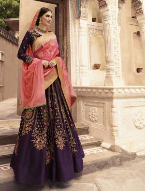 Catch All The Lime Light This Wedding Season Wearing This Heavy Designer Lehenga Choli In Purple Color Paired With Pink Colored Dupatta. Its Blouse And Lehenga Are Fabricated On Tafeta Art Silk Paired With A Net Fabricated Dupatta And Banarasi Art Silk Dupatta. You Pair With Any Of The Dupatta As Per Your Choice. 
