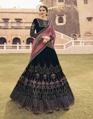 You Will Definitely Earn Lots Of Compliments Wearing This Heavy Designer Lehenga Choli In Navy Blue Color Paired With Contrasting Pink Colored Dupatta. Its Blouse And Lehenga Are Fabricated On Velvet Paired With Net Fabricated Dupatta. All Its Fabrics Esnures Superb Comfort All Day Long. 