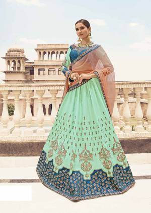 Adorn A Pretty Refreshing Look In The Fresh Shades Of Blue And Green. Grab This Heavy Designer Lehenga Choli In Blue Colored Blouse Paired With Sea Green Colored Lehenga And Contrasting Peach Colored Dupatta. This Lehenga Choli Is Fabricated On Art Silk Paired With Net Fabricated Dupatta. 
