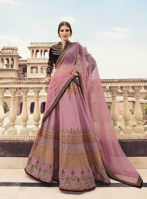 Look Beautiful In This Heavy Designer Lehenga Choli In Dark Wine Colored Blouse Paired With Pink Colored Lehenga And Dupatta. Its Blouse Is Fabricated On Velvet Paired With Oragenza Fabricated Lehenga And Net Fabricated Dupatta. Its Pretty Girly Color Pallete Will earn You Lots Of Compliments From Onlookers. 