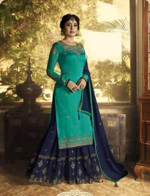 This Festive Season, Give A New Look To Yourself With This Designer Semi-Stitched Suit In Sea Green Color Paired With Contrasting Navy Blue Colored Bottom And Dupatta. Its Top Is Fabricated On Satin Georgette Paired With Georgette Bottom And Dupatta. It Is Beautified With Attractive Embroidery Over The Top And Bottom. 