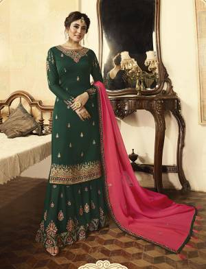 Celebrate This Festive Season With Ease And Comfort And With Beauty Wearing This Designer Suit In Dark Green Color Paired With Contrasting Dark Pink Colored Dupatta. Its Top Is Fabricated On Satin Georgette Paired With Georgette Bottom And Dupatta. Its Fabrics Ensures Superb Comfort Throught Out The Gala.