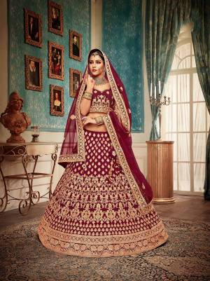 Here Is A Perfect Bridal Look For You With This Heavy designer Lehenga Choli In Maroon Color. This Lehenga Choli Is Velvet Based Paired With Net Fabricated Dupatta.Its Fabric Also Ensures Superb Comfort Throughout The Gala