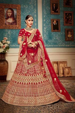 Get Ready For Your Big Day With This Heavy Designer Lehenga Choli?In Red Color. This Heavy Embroidered Lehenga Choli Is Fabricated On Velvet Paired With Net Fabricated Dupatta. It Is Beautified With Heavy Jari & Thread Embroidery and Stone Work. Buy Now