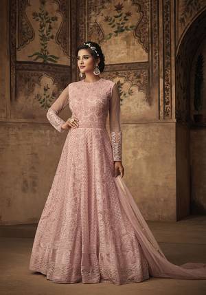 Look Pretty Wearing This Heavy Embroidered Designer Floor Length Suit In Baby Pink Color. Its Top And Dupatta Are Fabricated On Net Paired With Satin Based Bottom. Its Pretty Color And Heavy Embroidery With Earn You Lots Of Compliments From Onlookers. 