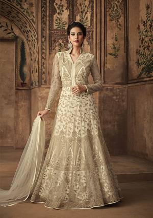 Simple And Elegant Looking Heavy Designer Floor Length Suit Is Here In Off-White Color Paired With Off-White Colored Bottom And Dupatta. Its Embroidered Top Is Fabricated On Net Paired With Satin Bottom And Net Fabricated Dupatta. 