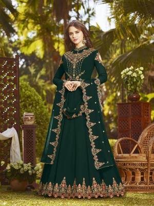 Here Is A Beautiful Shade In Green With This Designer Floor Length Suit In Pine Green Color Paired With Pine Green Colored Bottom And Dupatta. Its Top And Dupatta Are Fabricated On Georgette Beautified With Heavy Embroidery Paired With Santoon Fabricated Bottom, Its Rich Fabric And Color Will Earn You Lots Of Complimsnts From Onlookers.