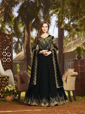 For A Bold And Beautiful Look, Grab This Heavy Designer Floor Length Suit In Black Color Paired With Black Colored Bottom And Dupatta. Its Heavy Embroidered Top And Dupatta Fabricated On Georgette Paired With Santoon Bottom. Get This Semi-Stitched Suit Now.