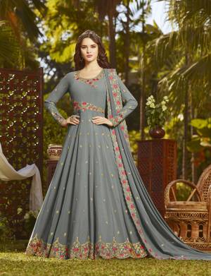 Flaunt Your Rich And Elegant Taste Wearing This Designer Floor Length Suit In Grey Color Paired With Grey Colored Bottom And Dupatta. Its Heavy Embroidered Top And Dupatta Are Fabricated On Georgette Paired With Santoon Bottom. It Has Attractive Contrasting Colored Embroidery. 