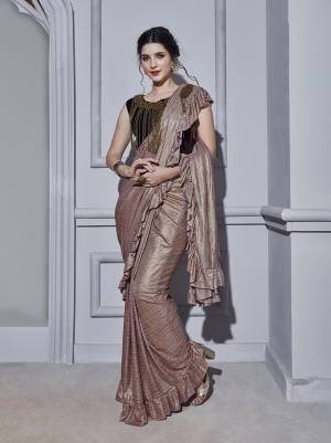 Look Pretty Wearing This Designer Ready To Wear Saree In Dusty Pink Color Paired With Dark Wine Colored Blouse. This Saree And Blouse Are Fabricated On Fancy Fabric Beautified Pretty Hand Work Making It More Attractive. Buy this Designer Saree Now.