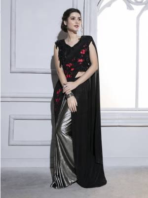 Deck Up With all That Jazz Wearing This Designer Ready To Wear Saree In Black And Silver Paired With Black Colored Blouse. This Saree And Blouse Are Fancy Fabric Based Which Is Durable, Light Weight And Easy To Carry All Day Long. 