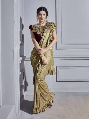 Get Ready For The Upcoming Wedding Season With This Designer Ready To Wear Saree In Golden Color Paired With Royal Maroon Colored Blouse. This Saree And Blouse Are Fabricated On Fancy Fabric Beautified  With Hand Work Over Blouse And Patch Work. 