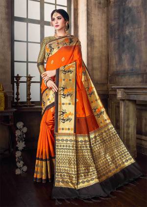 Bright And Visually Appealing Color Is Here With This Designer Saree In Orange Color Paired With Black & Gold Colored Blouse. This Saree And Blouse Are Fabricated On Banarasi Poly silk Beautified With Weave, Buy Now.