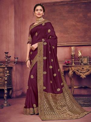 Bring out the best in you when wearing this Wine color two tone silk fabrics saree. Ideal for party, festive & social gatherings. this gorgeous saree featuring a beautiful mix of designs. Its attractive color and heavy designer embroidered saree, gotta design, stone design, beautiful floral design all over work over the attire & contrast hemline adds to the look. Comes along with a contrast unstitched blouse.