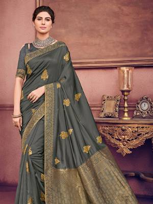 marvelously charming is what you will look at the next wedding gala wearing this beautiful Dark grey color two tone silk fabrics saree. Ideal for party, festive & social gatherings. this gorgeous saree featuring a beautiful mix of designs. Its attractive color and heavy designer embroidered saree, beautiful floral design all over work over the attire & contrast hemline adds to the look. Comes along with a contrast unstitched blouse.