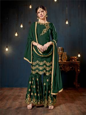 Get Ready For The Upcoming Festive And Wedding Season With This Heavy Designer Sharara Suit In Dark Green Color. Its Top And Bottom Are Fabricated On Satin Georgette Paired With Chiffon Fabricated Dupatta. It Is Beautified Heavy Embroidery Over The Top And Bottom Both. 