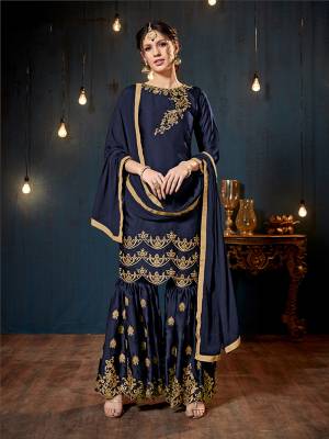 Get Ready For The Upcoming Festive And Wedding Season With This Heavy Designer Sharara Suit In Navy Blue Color. Its Top And Bottom Are Fabricated On Satin Georgette Paired With Chiffon Fabricated Dupatta. It Is Beautified Heavy Embroidery Over The Top And Bottom Both. 