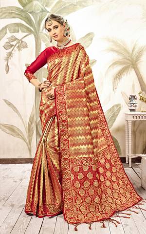 This Festive Season, Look The Amazing Of All In This Silk Based Red And Gold Colored Saree Paired With Red Colored Blouse. This Saree Is Fabricated On Kanjivaram Art Silk Paired With Art Silk Fabricated Blouse. 