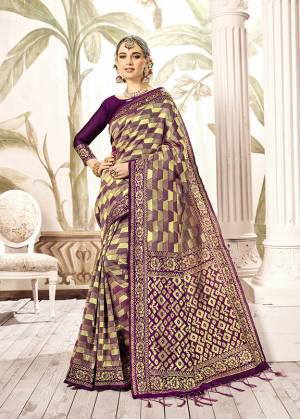 Shine Bright Wearing This Designer Silk Based Saree In Dark Purple And Gold Paired With Dark Purple Colored Blouse. This Saree Is Fabricated On Kanjivaram Art Silk Paired With Art Silk Fabricated Blouse. It Is Beautified With Weave All Over. 