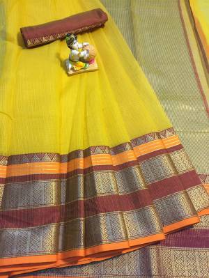 Grab This Rich Looking Saree In Yellow Color Paired With Contrasting Rust Colored Blouse. This Saree And Blouse Are Fabricated On Cotton Silk Which Gives A Rich Look To Your Personality. 