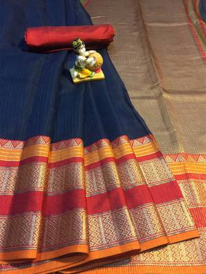 Grab This Rich Looking Saree In Navy Blue Color Paired With Contrasting Orange Colored Blouse. This Saree And Blouse Are Fabricated On Cotton Silk Which Gives A Rich Look To Your Personality. 