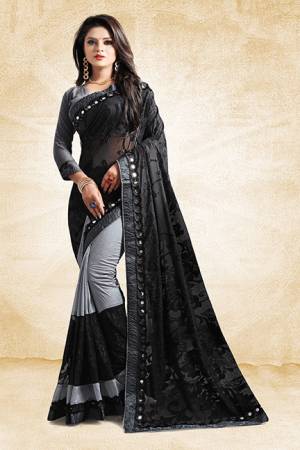 Get Ready For The Next Party At Your Place With This Designer Saree In Grey And Black Color Paired With Grey Colored Blouse. This Saree Is Fabricated On Art Silk And Brasso Paired With Art Silk Fabricated Blouse. Its Unique Pattern Will Earn You Lots Of Compliments From Onlookers. 