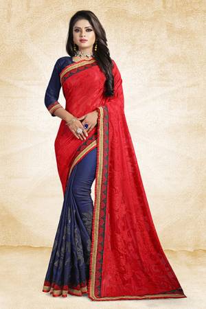 Go Colorful With This Pretty Bright Color Pallete Designer Saree In Red And Navy Blue Color Paired With Navy Blue Colored Blouse. This Saree Is Fabricated On Brasso And Satin Silk Paired With Art Silk Fabricated Blouse. It Has Very Attractive Stone Work Over The Saree Panel. 