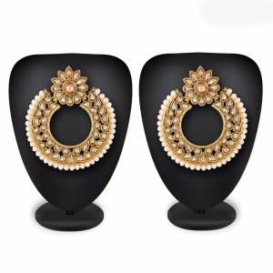 Grab This Beautiful And Attractive Pair Of Heavy Earrings Set In?Golden Color. This Pretty Pair Is Beautified With Stone Work And Can Be Paired With Any Colored Traditional Attire. Buy Now.