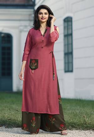 Grab This Beautiful Designer Readymade Set In Pink colored Kurti Paired With Contrasting Brown Colored Plazzo. Its Top And Bottom Are Fabricated On Rayon Beautified With Prints And Thread Work. It Is Available In All Regular Sizes. 