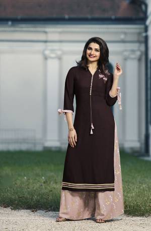 Look Beautiful Wearing This Designer Readymade Set In Dark Wine Colored Kurti Paired With Baby Pink Colored Plazzo. This Kurti And Plazzo Are Fabricated On Rayon Beautified With Prints And Thread Work. It Is Light Weight And Easy To Carry All Day Long. 