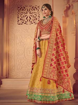 Wear this red and yellow color jacquard fabrics and satin lehenga. Ideal for party, festive & social gatherings. this gorgeous lehenga featuring a beautiful mix of designs. Its attractive color and designer heavy embroidered lehenga with jacquard dupatta and fancy blouse, stone design, beautiful floral design work over the attire & contrast hemline adds to the look. Comes along with a contrast unstitched blouse.