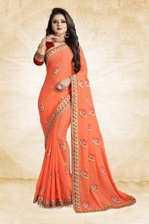 Celebrate This Festive Season With Beauty And Comfort Wearing This Designer Saree In Orange Color Paired With Contrasting Red Colored Blouse. This Saree And Blouse Are Silk Based Beautified With Embroidered Butti All Over It. It Is Easy to Drape And Durable. 