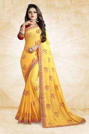 Celebrate This Festive Season With Beauty And Comfort Wearing This Designer Saree In Yellow Color Paired With Contrasting Red Colored Blouse. This Saree And Blouse Are Silk Based Beautified With Embroidered Butti All Over It. It Is Easy to Drape And Durable. 