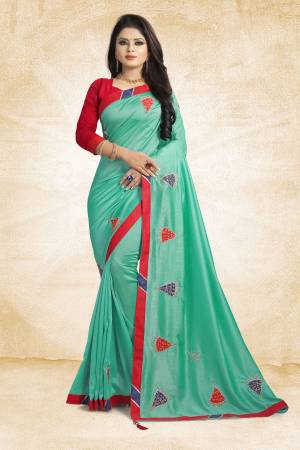 For Your Semi-Casuals, Add This Pretty Sea Green Colored Designer Saree To Your Wardrobe Paired With Red Colored Blouse. This Saree And Blouse Are Silk Based Beautified With Simple Butti Work. Grab It Now.