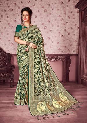 For a Bold And Beautiful Look, Grab This Heavy Woven Designer Silk Based Saree In Green And Gold Color Paired With Green Colored Blouse. This Saree Is Fabricated On Kanjivaram Art Silk Paired With Art Silk Fabricated Blouse. It Is Beautified With Heavy Weave All Over The Saree.