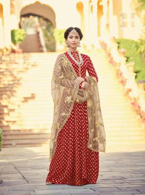 For A Royal And elegant Look, Grab This Heavy Designer Floor Length Suit In Red Colored Top And Bottom Paired With Beige Colored Dupatta. Its Top Is Fabricated On Viscose Jacquard Paired With Santoon Bottom And Net Fabricated Embroidered Dupatta. Its Rich Color Pallete Will Earn You Lots Of Compliments From Onlookers. 
