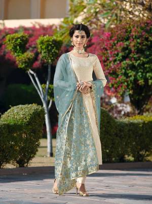 Simple And Elegant Looking Designer Straight Suit Is Here In Cream Colored Top And Bottom Paired With Light Blue Colored Dupatta. Its Top And Bottom Are Fabricated On Brocade Jacquard Paired With Embroidered Net Fabricated Dupatta. 