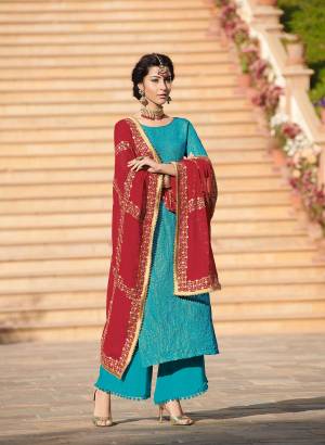 Celebrate This Festive Season With This Beautiful Designer Straight Suit In Blue Color Paired With Contrasting Red Colored Dupatta. Its Top IS Fabricated On Brocade Jacquard Paired With Santoon Bottom And Chiffon Dupatta. All Its Fabrics Ensures Superb Comfort Throughout The Gala. Buy Now.