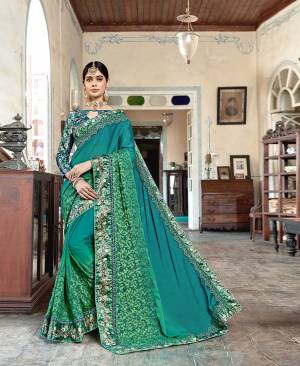 Shine Bright In This Designer Sea Geeen Color Paired With Sea Green Colored Blouse. This Saree Is Fabricated On Silk Georgette Paired With Satin Silk Fabricated Blouse. It Is Beautified With Floral Prints And Embroidery. 