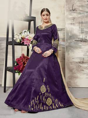 Grab This Designer Floor Length Suit In Purple Color Paired With Beige Colored Dupatta. Its Elegant Embroidered top Is Fabricated On Art Silk Paired With santoon Bottom And Net Fabricated Dupatta. All Its Fabrics Ensures Superb Comfort All Day Long. Buy This Designer Suit Now For The Upcoming Festive And Wedding Season. 