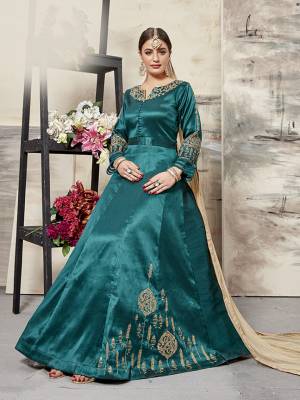 Grab This Designer Floor Length Suit In Teal Blue Color Paired With Beige Colored Dupatta. Its Elegant Embroidered top Is Fabricated On Art Silk Paired With santoon Bottom And Net Fabricated Dupatta. All Its Fabrics Ensures Superb Comfort All Day Long. Buy This Designer Suit Now For The Upcoming Festive And Wedding Season. 