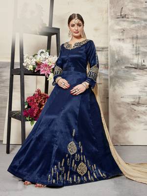 Grab This Designer Floor Length Suit In Navy Blue Color Paired With Beige Colored Dupatta. Its Elegant Embroidered top Is Fabricated On Art Silk Paired With santoon Bottom And Net Fabricated Dupatta. All Its Fabrics Ensures Superb Comfort All Day Long. Buy This Designer Suit Now For The Upcoming Festive And Wedding Season. 