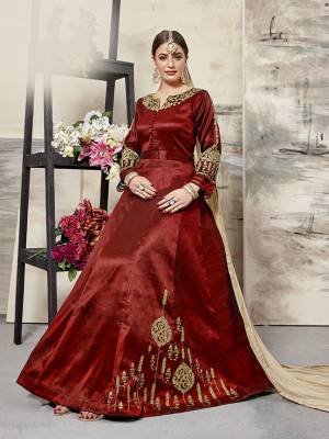 Grab This Designer Floor Length Suit In Red Color Paired With Beige Colored Dupatta. Its Elegant Embroidered top Is Fabricated On Art Silk Paired With santoon Bottom And Net Fabricated Dupatta. All Its Fabrics Ensures Superb Comfort All Day Long. Buy This Designer Suit Now For The Upcoming Festive And Wedding Season. 
