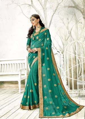 Rich And Elegant Looking Designer Saree Is Here In Sea Green Color Paired With Sea Green Colored Blouse. This Saree Is Fabricated On Chiffon Paired With Art Silk Fabricated Blouse. Both Its Fabrics Are Light Weight And Easy To Carry All Day Long. 