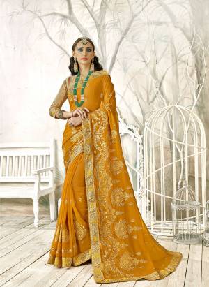 Enhance Your Personality Wearing This Heavy Designer Saree In Yellow Color Paired With Golden Colored Blouse. This Saree Is Georgette Based With Heavy Embroidery Paired With Art Silk Fabricated Blouse. 